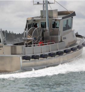 Side view of a North River Bristol Bay aluminum fishing boat on the water.